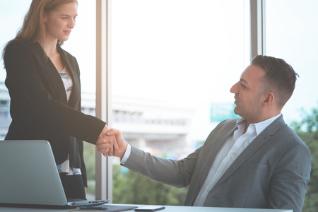 Business handshake between male and female business manの写真素材
