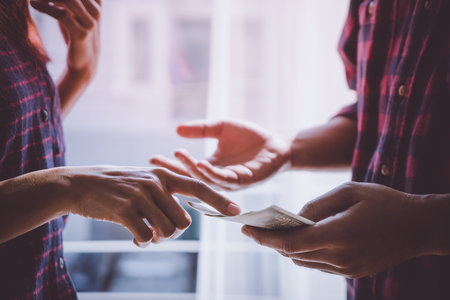 Business man hands handing money over a business dealing