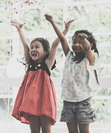 Kids are playing and throwing paper in kid partyの写真素材