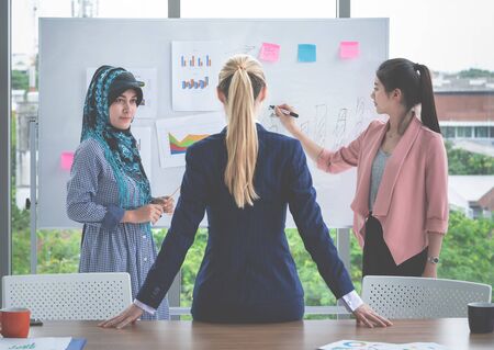 Female boss leader is listening to presentation by female workerの写真素材