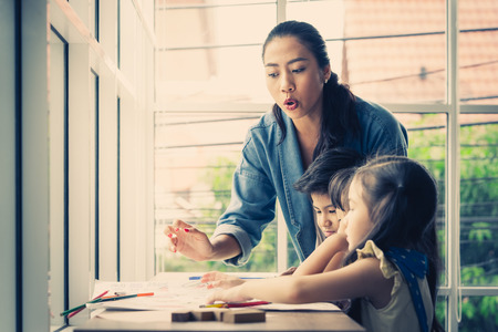Student kids are painting on paper in Art groupの写真素材