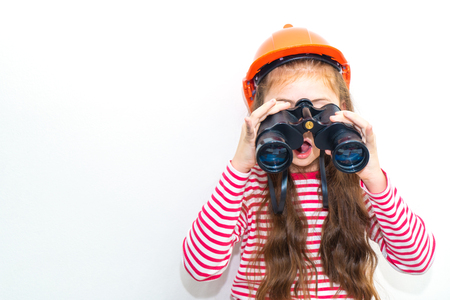 Little girl explorer is looking through binocularsの写真素材