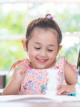 Asian girl is painting on dolls in Art groupの写真素材