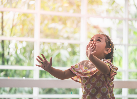 One Asian baby girl is throwing paper partyの写真素材