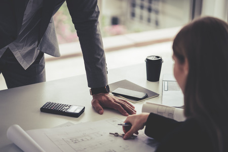 Female architect is showing her boss the real estate building planの写真素材