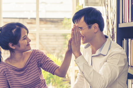 Business lover couple is hi five for success in family businessの写真素材