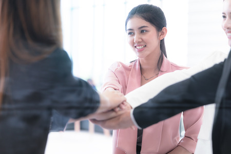 Young people placing hand together for team unity conceptの写真素材