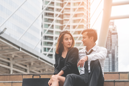 Office woman with business man couple lover talking flirting outdoorの写真素材