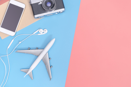 Travel top view gadgets and objects for business traveler on blue yellow pink copy spaceの写真素材
