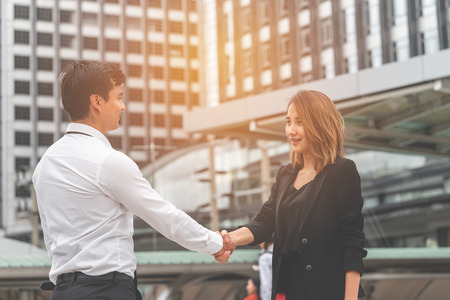 business woman with confidence handshake with business man partner outdoorの写真素材