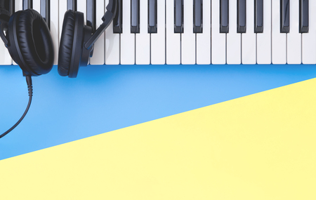 Music keyboard instrument with headphone on blue yellow copy space for Music conceptの写真素材
