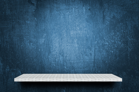Empty counter shelf on blue cement wallの写真素材