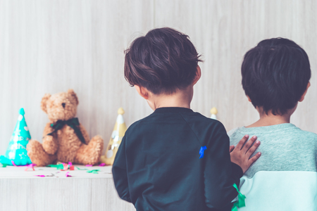 Two boys playing together in birthday partyの写真素材