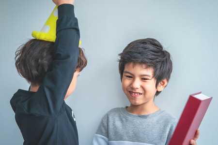 Two boys playing together in birthday partyの写真素材