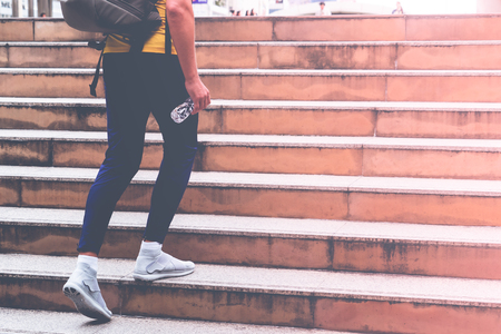 Male sport man is walking up the stair in modern cityの写真素材