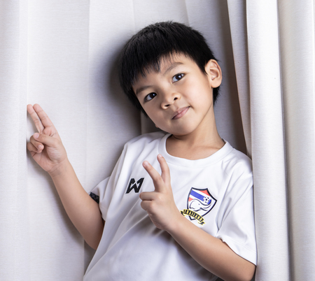 Bangkok, Thailand - november 16, 2018: little boy wearing Thai soccer team shirt suppoting Thai national team.の写真素材