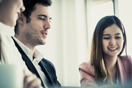 Business woman is falling in love with boss at workの写真素材