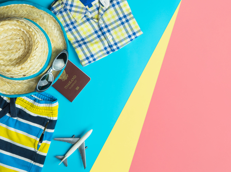 Beach Summer Vacation travel accessories and fashion on Sand and blue pink yellow backgroundの写真素材