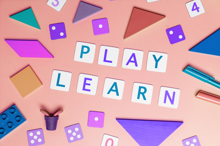 Children play and learn concept with toys top view flat lat on pinkの写真素材