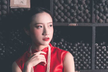 Chinese woman in a steel metal rod industrial storeの写真素材