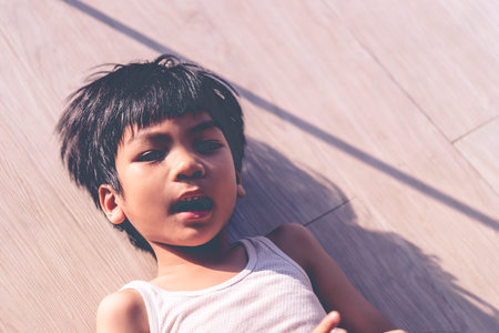 Asian Boy portrait lying on the floor top view