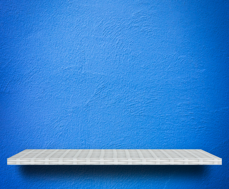 Empty white shelf on blue background for product displayの写真素材