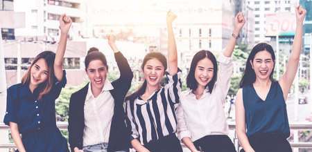 Business team of woman friend hand up for happy successful conceptの写真素材