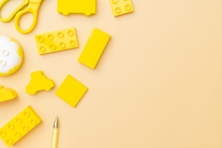 Kids toys on yellow background with toys flat lay top view with empty center