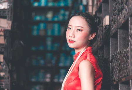 Chinese woman in a steel metal rod industrial storeの写真素材