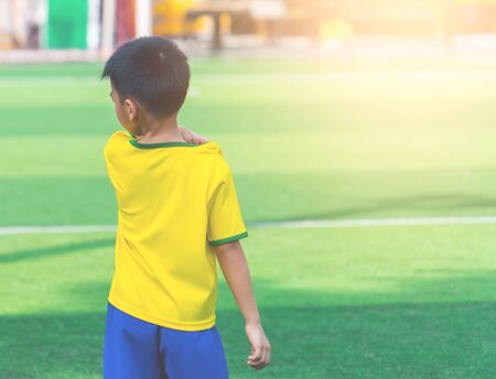 Soccer Boy is standing alone on training groundの写真素材
