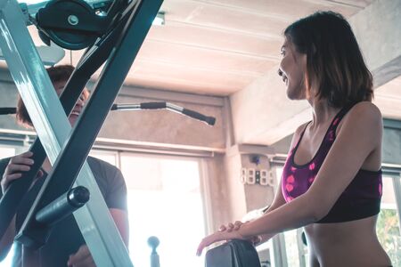 Female and Male athlete is flirting and chatting in fitness gymの写真素材