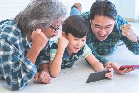 Multi generation family having success time using mobile Internet technologyの写真素材