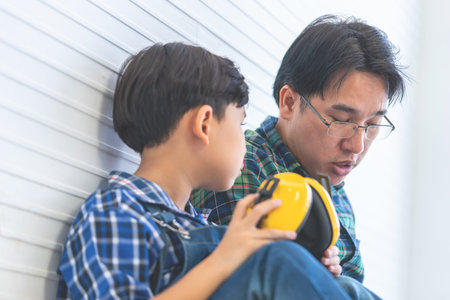 Father is putting on headphone for his son