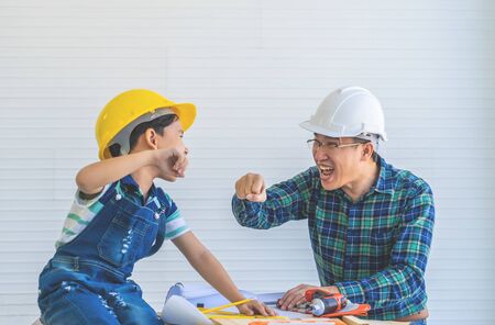Father and Son fist bump for success concept in construction industry concept.の写真素材