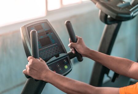 unrecognized Senior hands is working out on fitness machine for elder healthy conceptの写真素材