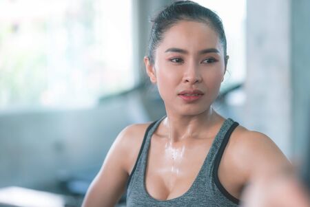 Healthy Woman body is sweating while they exercising in Fitness Gymの写真素材