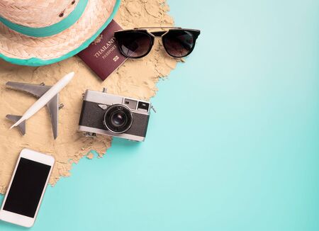 Beach Summer Vacation travel accessories and fashion on Sand and blue backgroundの写真素材