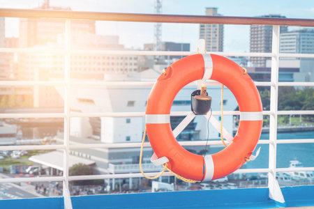 Orange lifebouy life loop on a ocean cruise ship for Sea and Ferry travel safety concept. Marine...