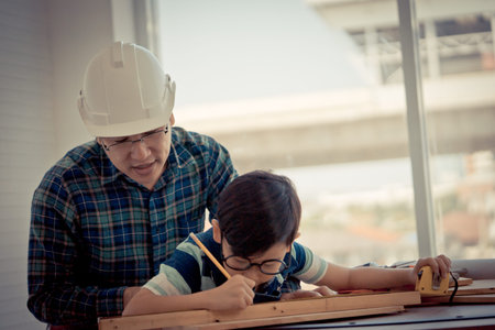 Little Boy is learning to work on wood and be a builder from his craftman father in vintage tone