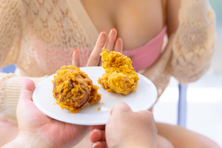 Woman hand is rejecting to eat fried chicken for healthy and diet food concept.