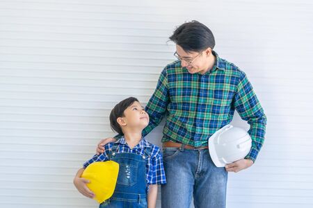 Builder father is Stading next to his son for family connection concept in vintage toneの写真素材