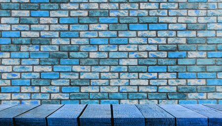 Blue display wooden board shelf table counter with copy space for advertising backdrop and background with blue brick wall in the background,の写真素材
