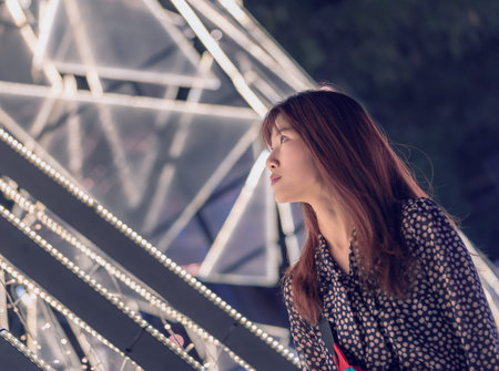 Portrait of a woman on blurry Bokeh light background in Outdoor Festive Market