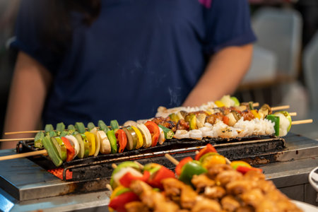 Retailer is grilling BBQ skewer on Hot griller for customerの写真素材