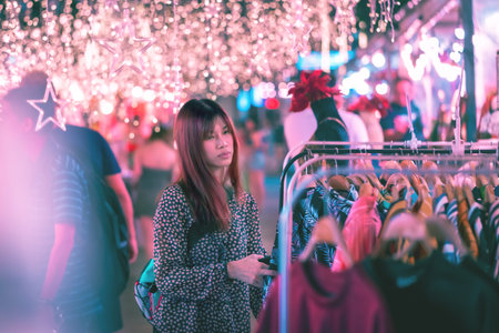 Lonely woman is shopping alone in outdoor marketの写真素材