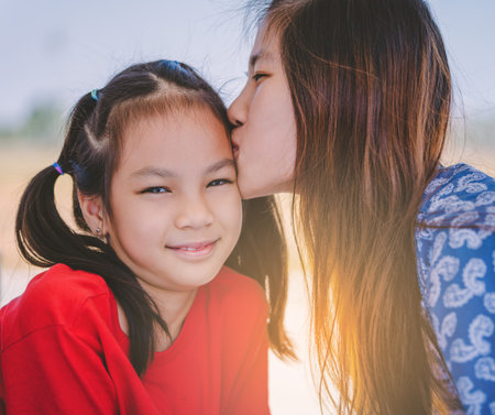 Asian Mother and Duaghter is kissing and hugging for Love and affection and Family togetherness...
