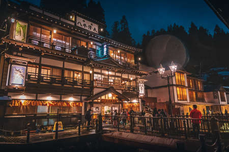 Yamagata; Japan - 27 Dec 2019: Tourists are traveling the Famous Ginzan onsen while snow is falling down.のeditorial素材