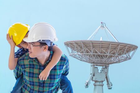 Father builder is carrying his son  in modern settle lite Communication receiver for Internet industry and family boding future conceptの写真素材