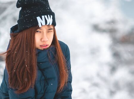 beauty attractive woman with winter fashion clothing with beautiful skin face in snow skii resort, closed up portrait.の写真素材