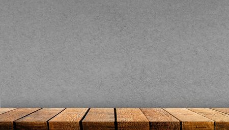 Empty display wooden board shelf table counter with copy space for advertising backdrop and background with gray paper wall background,の写真素材